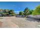 Spacious backyard featuring a playground, mature trees, and secure fencing for outdoor enjoyment at 6821 Jeanette St, Las Vegas, NV 89131