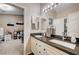 Bathroom featuring double sinks, a large mirror, and views into an adjacent room at 6821 Jeanette St, Las Vegas, NV 89131