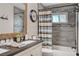 Bathroom featuring wood-look tile, updated vanity and mirror and shower with decorative curtain at 6821 Jeanette St, Las Vegas, NV 89131