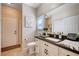 Well-lit bathroom featuring a stylish vanity with a sink, toilet, and neutral colored walls at 6821 Jeanette St, Las Vegas, NV 89131
