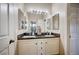 Bathroom featuring double sinks, a large mirror, and views into an adjacent room at 6821 Jeanette St, Las Vegas, NV 89131