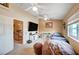 Cozy bedroom with two ceiling fans, a window view, and a large beanbag chair at 6821 Jeanette St, Las Vegas, NV 89131