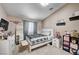 Well-lit bedroom with a window, a mirror, and dresser storage with decorative items at 6821 Jeanette St, Las Vegas, NV 89131