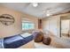 Comfortable bedroom featuring a ceiling fan, beanbag chairs and a window view at 6821 Jeanette St, Las Vegas, NV 89131