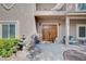 Elegant front entrance showcasing a double door, water feature, and cozy seating area at 6821 Jeanette St, Las Vegas, NV 89131