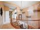 Bright hallway features a wooden banister, unique light fixtures, and decorative wall shelves at 6821 Jeanette St, Las Vegas, NV 89131