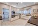 An updated kitchen with white cabinetry, stainless steel appliances, and a view into the laundry room at 6821 Jeanette St, Las Vegas, NV 89131