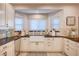 Beautiful kitchen featuring white cabinetry, a bay window, and an undermount sink at 6821 Jeanette St, Las Vegas, NV 89131