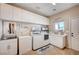 Efficient laundry room with built-in cabinets, modern washer and dryer, and ample counter space at 6821 Jeanette St, Las Vegas, NV 89131