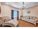 Cozy living room featuring hardwood floors, a decorative chandelier, and comfortable seating arrangements at 6821 Jeanette St, Las Vegas, NV 89131