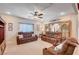 Spacious living room featuring dual sofas, neutral walls, plush carpeting, and a decoratively framed entryway at 6821 Jeanette St, Las Vegas, NV 89131