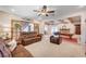 Comfortable living room with plush leather seating, a ceiling fan, and a fireplace at 6821 Jeanette St, Las Vegas, NV 89131