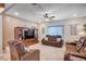 Inviting living room with a ceiling fan and comfortable brown leather furniture for relaxing and entertaining guests at 6821 Jeanette St, Las Vegas, NV 89131