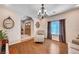 Elegant living room with hardwood floors, a chandelier, comfortable seating, and an entry door at 6821 Jeanette St, Las Vegas, NV 89131
