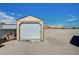 Durable backyard shed with a roll-up door, perfect for storage and organization at 6821 Jeanette St, Las Vegas, NV 89131