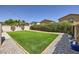 Serene backyard with lush artificial turf and mature landscaping at 7382 Elbridge Way, Las Vegas, NV 89113