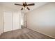 This bedroom features neutral carpet, a ceiling fan, and a closet for storage at 7382 Elbridge Way, Las Vegas, NV 89113
