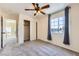 This bedroom features neutral carpet, a ceiling fan, closet, and a sunny window at 7382 Elbridge Way, Las Vegas, NV 89113