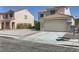 Two-story home showcasing desert landscaping, a tile roof, and an attached two-car garage at 7382 Elbridge Way, Las Vegas, NV 89113