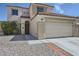 A two-story stucco home with tile roof, desert landscaping, and attached two-car garage at 7382 Elbridge Way, Las Vegas, NV 89113