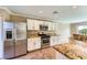 Well-lit kitchen with white cabinets and stainless steel appliances at 7382 Elbridge Way, Las Vegas, NV 89113