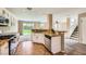 Open kitchen with granite countertops, tile flooring, and seamless flow to living area at 7382 Elbridge Way, Las Vegas, NV 89113