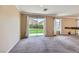 Bright living area with sliding glass doors offering views of the green backyard and lawn at 7382 Elbridge Way, Las Vegas, NV 89113