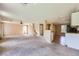 Bright living room with open floor plan, carpeting, and seamless flow to the kitchen at 7382 Elbridge Way, Las Vegas, NV 89113