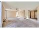Spacious living room featuring neutral tones, plush carpeting, and plenty of natural light at 7382 Elbridge Way, Las Vegas, NV 89113