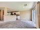 Open concept living space with plush carpeting and sliding glass door at 7382 Elbridge Way, Las Vegas, NV 89113