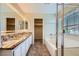 Elegant main bathroom with double sinks, granite countertops, a soaking tub, and a glass shower at 7382 Elbridge Way, Las Vegas, NV 89113