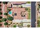 Stunning aerial view of a home with a private pool, desert landscaping, solar panels, and a tile roof at 7408 Via Fiorentino St, Las Vegas, NV 89131