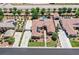 Expansive aerial view of a desert home featuring a private pool, solar panels, lush lawns, and generous driveway space at 7408 Via Fiorentino St, Las Vegas, NV 89131
