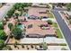 Beautiful aerial view of a home with a swimming pool, solar panels, and lush landscaping in a desert neighborhood at 7408 Via Fiorentino St, Las Vegas, NV 89131