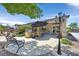 Inviting backyard patio featuring a built-in BBQ, comfortable seating, and lush landscaping, ideal for outdoor entertaining at 7408 Via Fiorentino St, Las Vegas, NV 89131