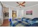 Bright bedroom with twin beds, hardwood floors, and a ceiling fan at 7408 Via Fiorentino St, Las Vegas, NV 89131