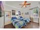 Bright bedroom featuring two twin beds, hardwood floors, and custom built-ins at 7408 Via Fiorentino St, Las Vegas, NV 89131