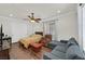 Cozy bedroom with hardwood flooring, a ceiling fan, and a sitting area at 7408 Via Fiorentino St, Las Vegas, NV 89131