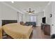 Comfortable bedroom with a ceiling fan, neutral decor, and warm lighting at 7408 Via Fiorentino St, Las Vegas, NV 89131