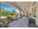 Relaxing covered patio overlooking a landscaped backyard with a pool at 7408 Via Fiorentino St, Las Vegas, NV 89131