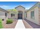 Attractive front entrance features a stone archway, iron doors and desert landscaping at 7408 Via Fiorentino St, Las Vegas, NV 89131