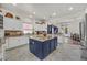 Gourmet kitchen boasting a center island, custom cabinets, modern appliances, and seamless flow to the dining area at 7408 Via Fiorentino St, Las Vegas, NV 89131