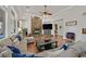 Spacious living room with a stone fireplace, wood floors, and comfortable seating at 7408 Via Fiorentino St, Las Vegas, NV 89131