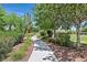 Tranquil community walking path lined with trees and greenery, perfect for a peaceful stroll at 7408 Via Fiorentino St, Las Vegas, NV 89131