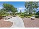Scenic community pathway with benches, providing a relaxing and pedestrian-friendly environment at 7408 Via Fiorentino St, Las Vegas, NV 89131