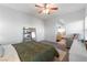 Bedroom with neutral walls, ceiling fan, bed, seating and view into the bathroom at 8036 Eurostar St, Las Vegas, NV 89131