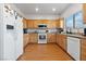 Modern kitchen with wood cabinets, white appliances, and stylish countertop details at 8036 Eurostar St, Las Vegas, NV 89131