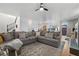 Open-concept living room with plush L-shaped sofa, hardwood floors, and natural light at 8036 Eurostar St, Las Vegas, NV 89131