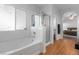 Bright bathroom featuring a soaking tub, glass-enclosed shower, and an open doorway to the bedroom at 8036 Eurostar St, Las Vegas, NV 89131