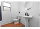 Clean powder room with pedestal sink, modern faucet, toilet, and small window at 8036 Eurostar St, Las Vegas, NV 89131